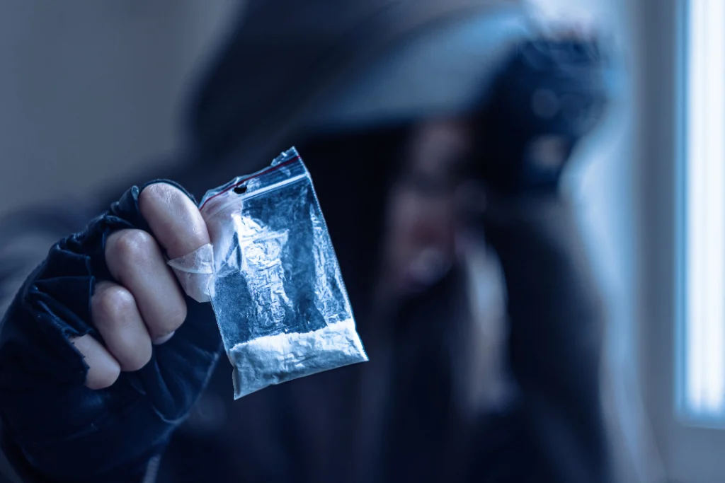 drug addict woman holding white powder