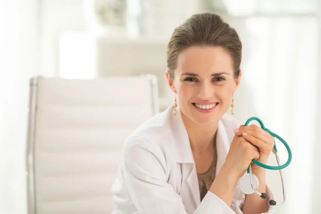 A female doctor holding a stethoscope.