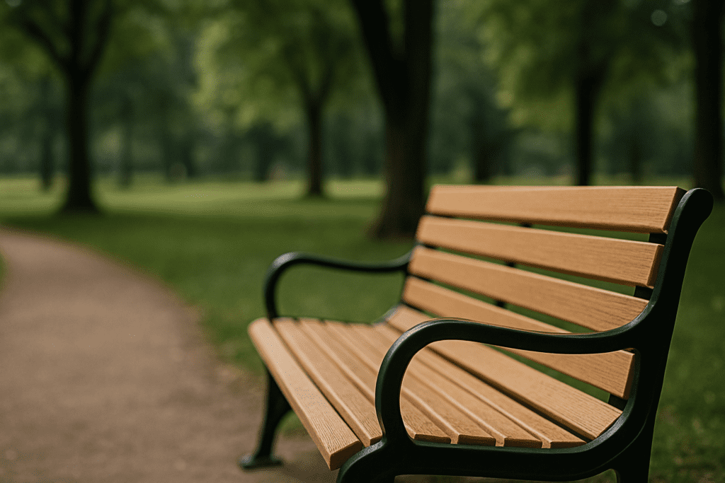 A wooden bench in a quiet, sunlit park with a soft-focus background of trees and grass — a peaceful outdoor space ideal for mindfulness and early symptom recognition of diabetic emergencies
